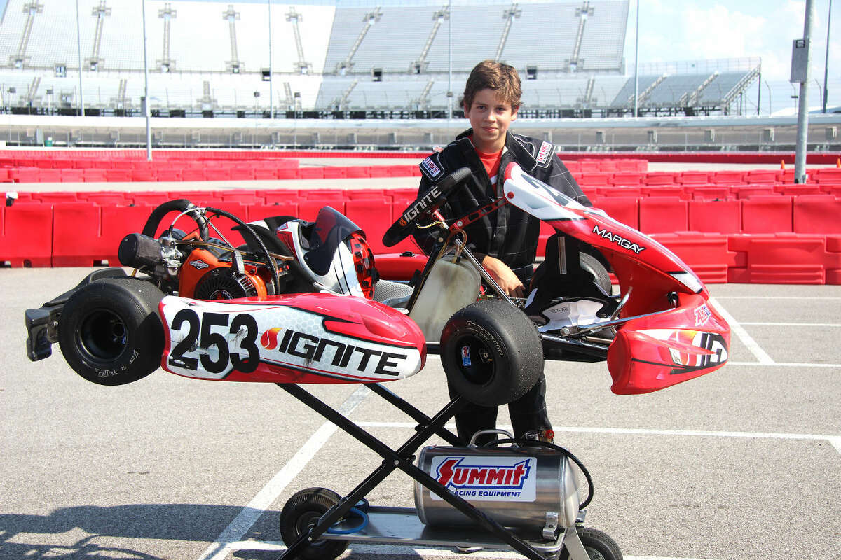 Evan Stamer, 13, of Edwardsville, poses with his kart at Gateway Kartplex, located inside Gateway Motorsports Park in Madison.