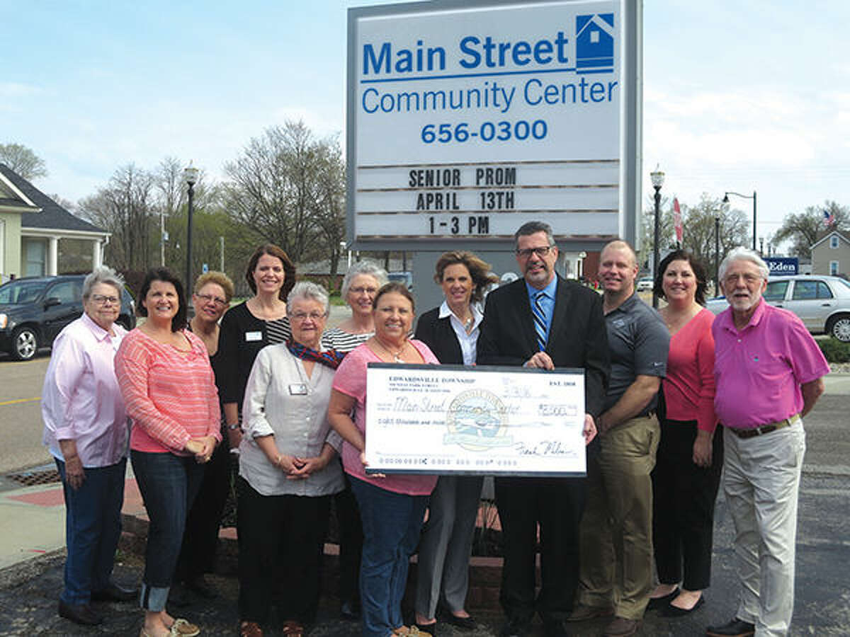 Township Supervisor Frank Miles, center right, presents Main Street Community Center Board Members with an $8,000 check to support programs at the Center.  Front row, from left: JoAnn Nabe, Deb Ellis, Fredna Scroggins, Kathie Duame, Supervisor Frank Miles, Greg Mefford, and Arnold Hoffman.  Back row, from left: Bev Meyer, Emily Bates, Sandy Cooper, Marcia Golden, and Sara Berkbigler, Executive Director of MSCC.