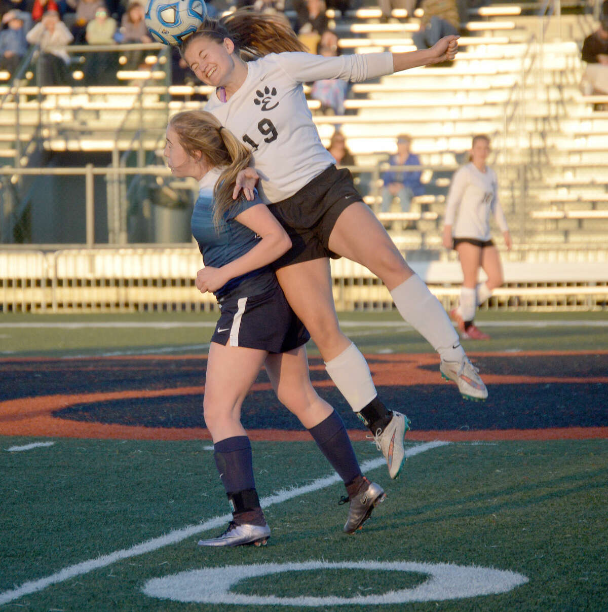Edwardsville senior Jane Ann Crabtree, right, tries to go over a Belleville Althoff defender for a header on Tuesday.
