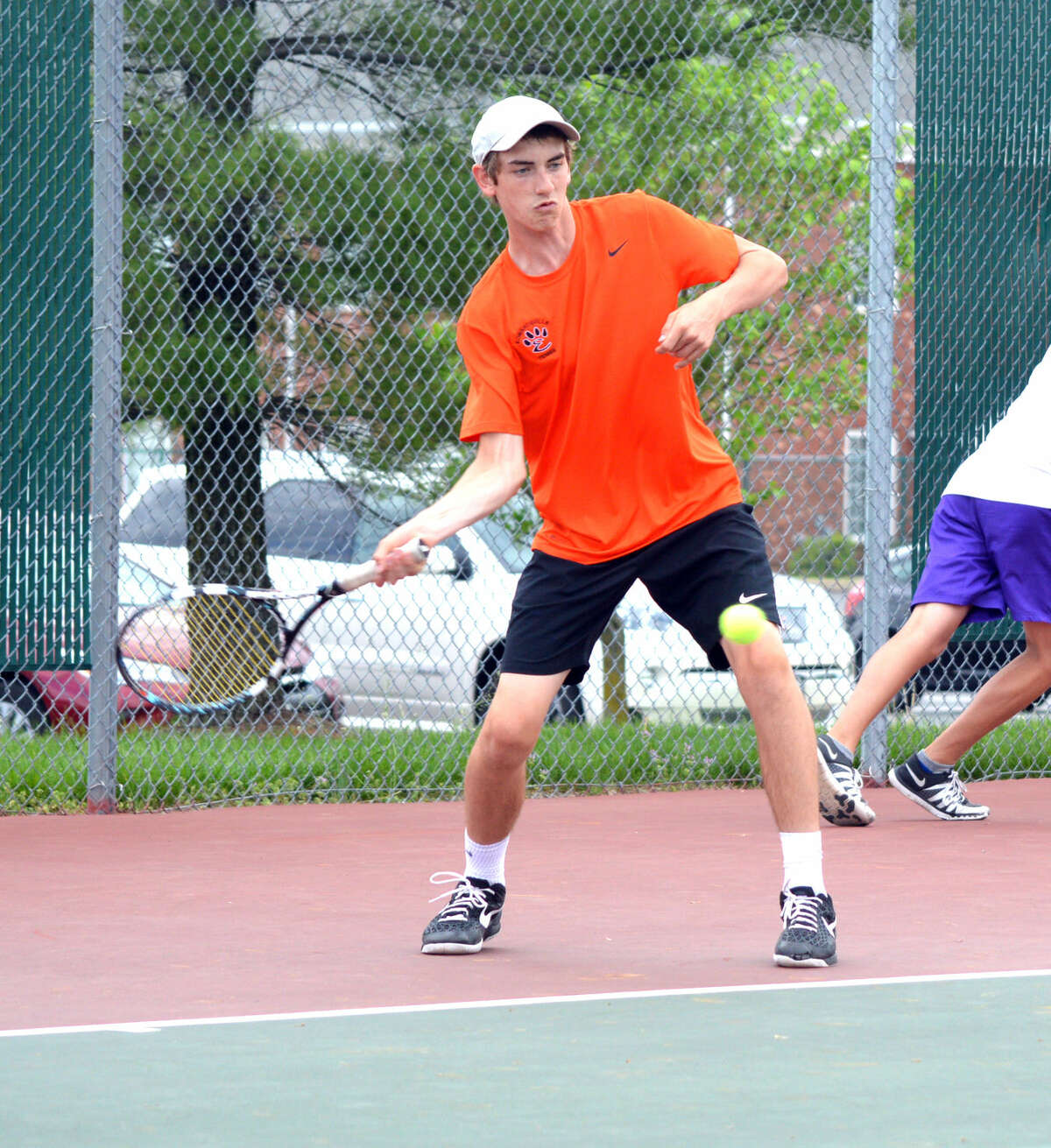 Edwardsville’s Dan Thomas prepares to hit a forehand during his No. 3 doubles match against Collinsville Thursday at the EHS Tennis Center.