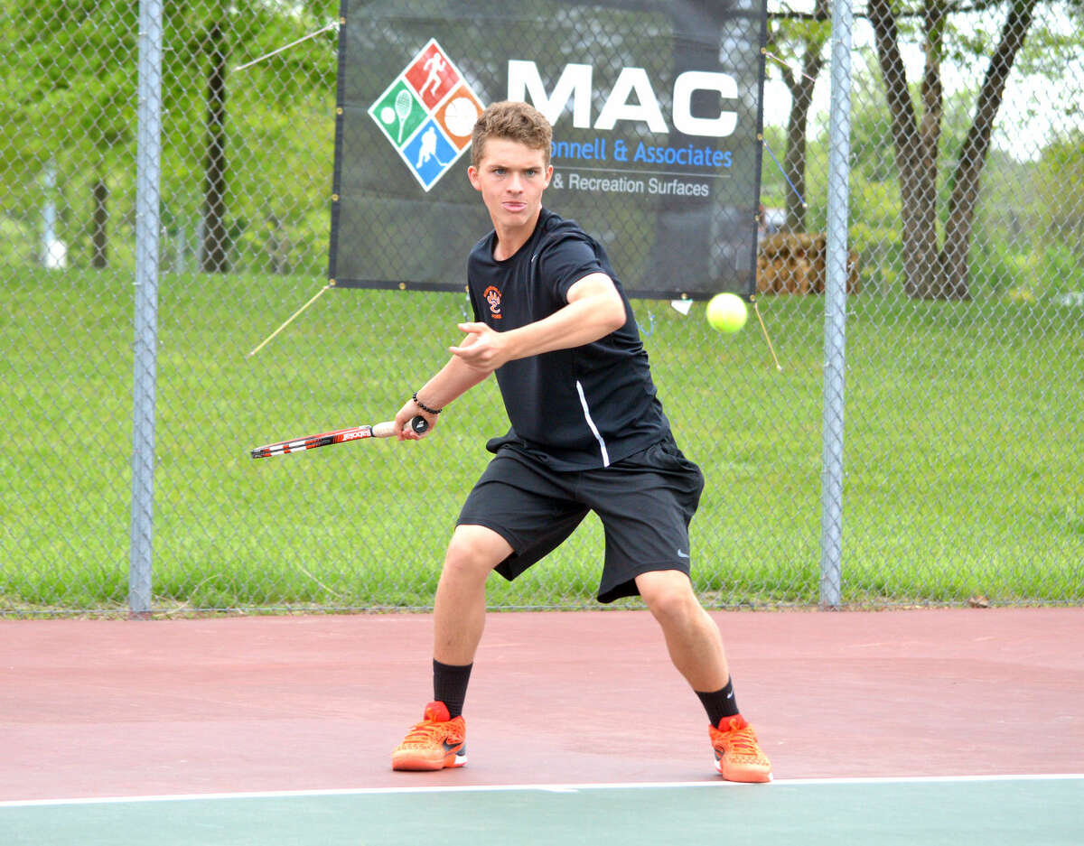 Edwardsville senior Carson Ware returns a shot during his No. 1 singles match against Springfield Sacred Heart-Griffin on Friday in the first round of the Tiger Duals at EHS.