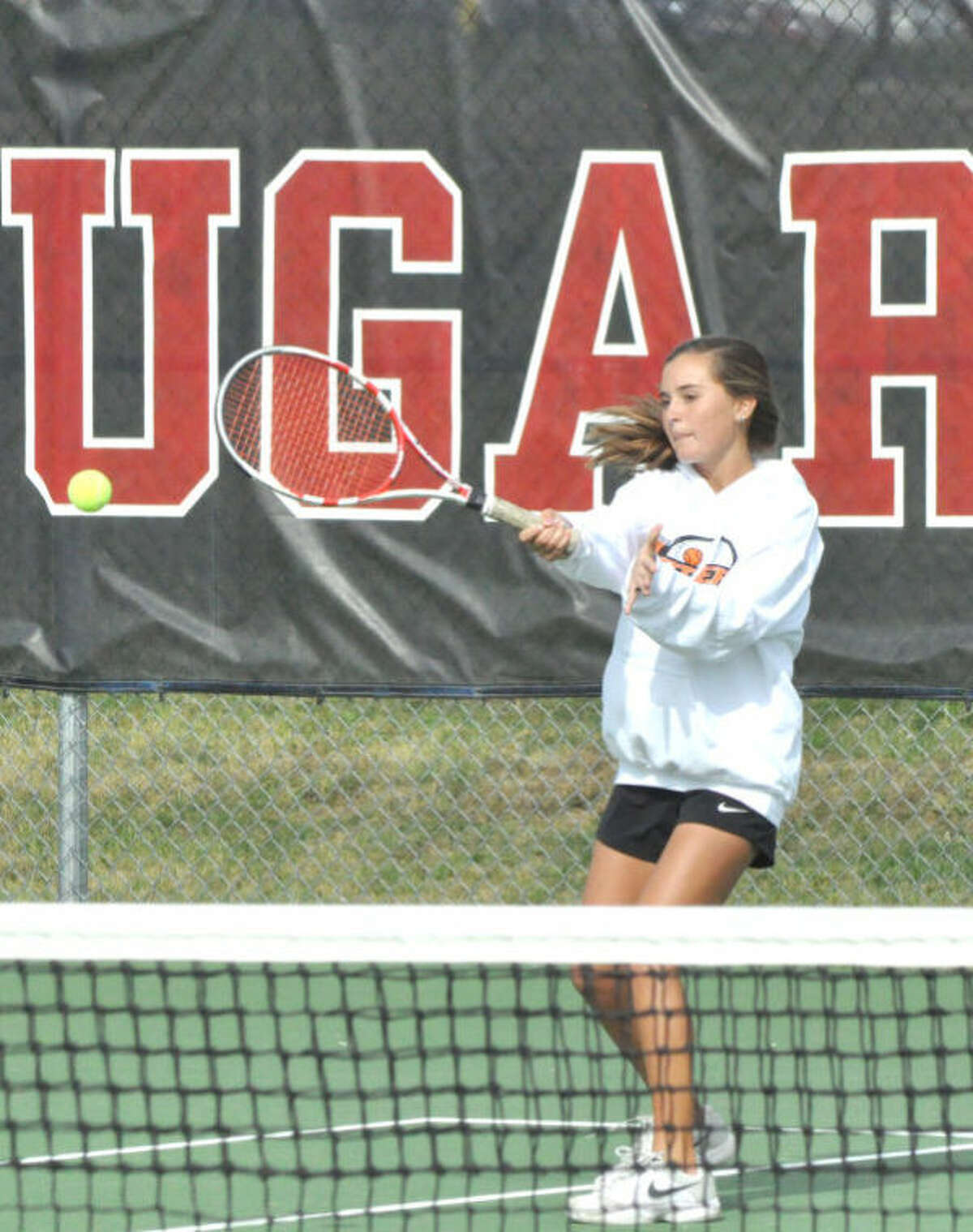 Edwardsville’s Emma Lipe hits a return on Monday in singles action of the Southwestern Conference Tournament at the SIUE tennis courts.