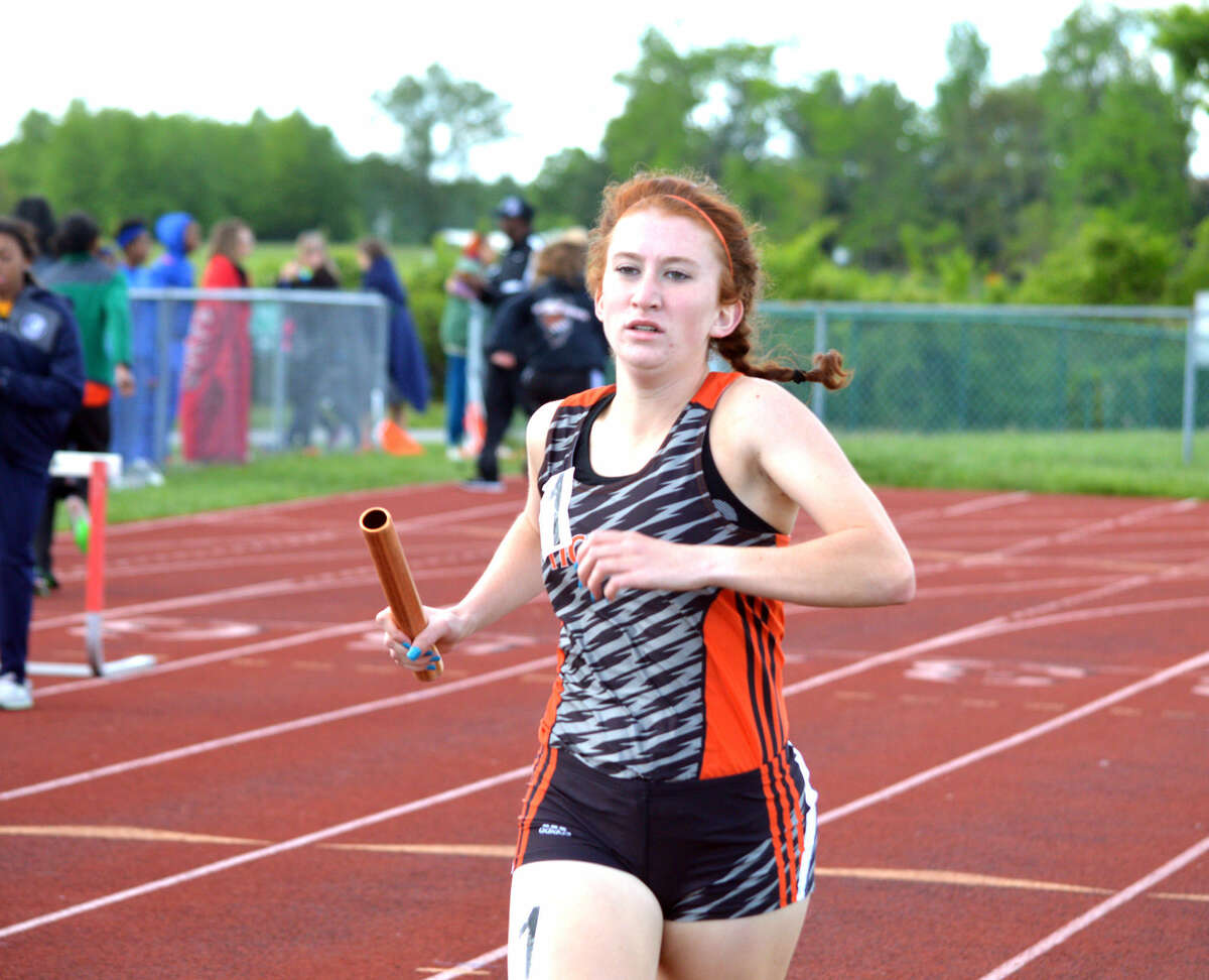 EHS junior Victoria Vegher runs the third leg of the 3,200-meter relay, which also took first place.