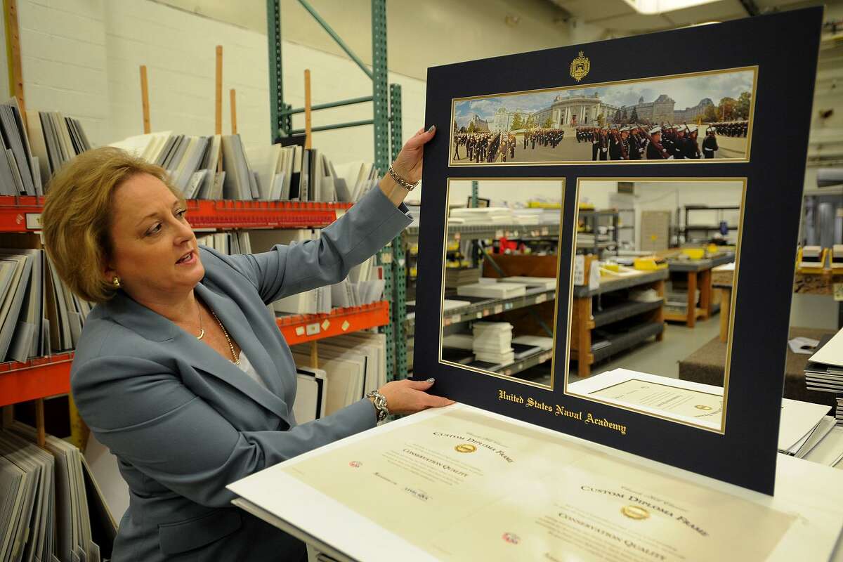 Lucie Voves, president and CEO of Church Hill Classics, shows an example of a mat which will be framed and for sale to graduates of the U.S. Naval Academy during a tour of the company in Monroe, Conn. on Tuesday, November 1, 2016.