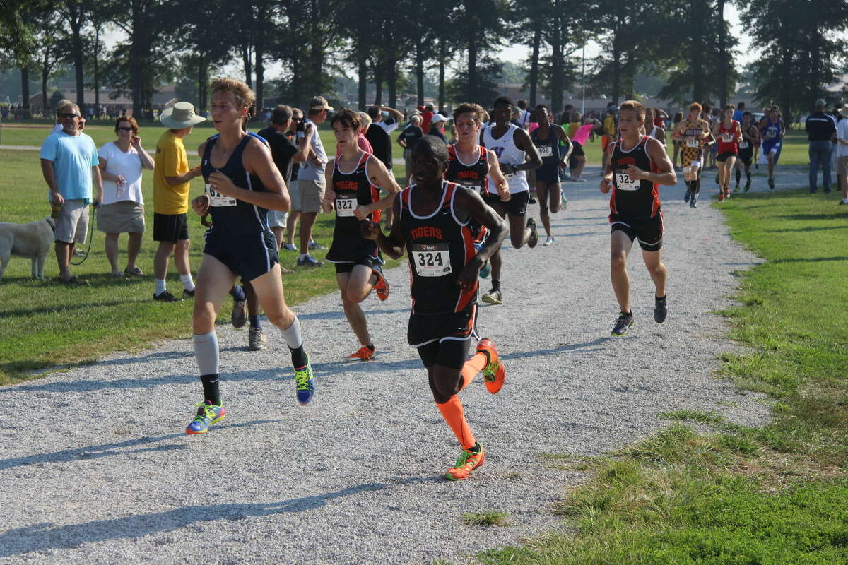 The boys' cross country team runs in a pack as they finish the first mile.