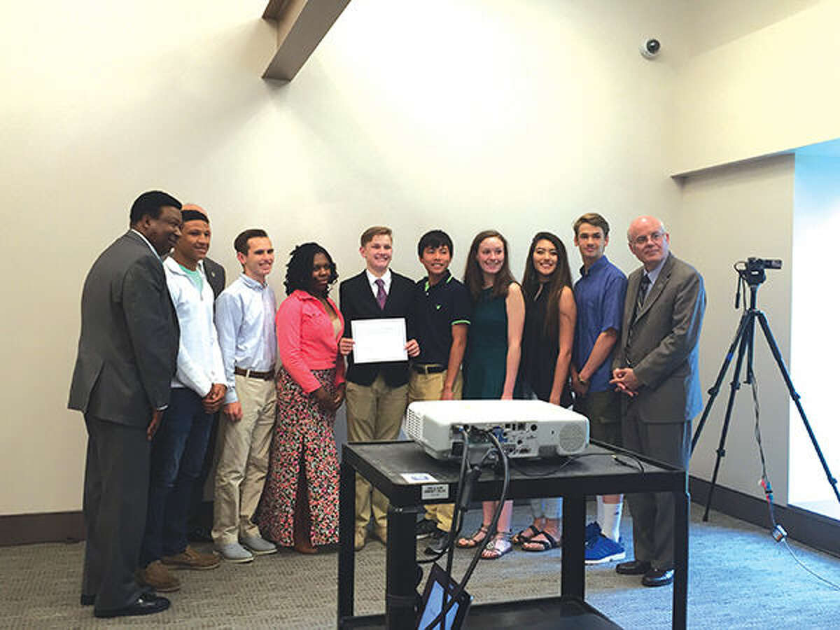 Flanked by Mannie Jackson Center for the Humanities Foundation Executive Director Ed Hightower, left, and Madison County Board Chairman Alan Dunstan, right, are EHS students Justin White, Michael Taplin, Montrice Spencer, Ian McLean, Jason Pan, Mary Webb, Lea Hein, Jared Engeman.