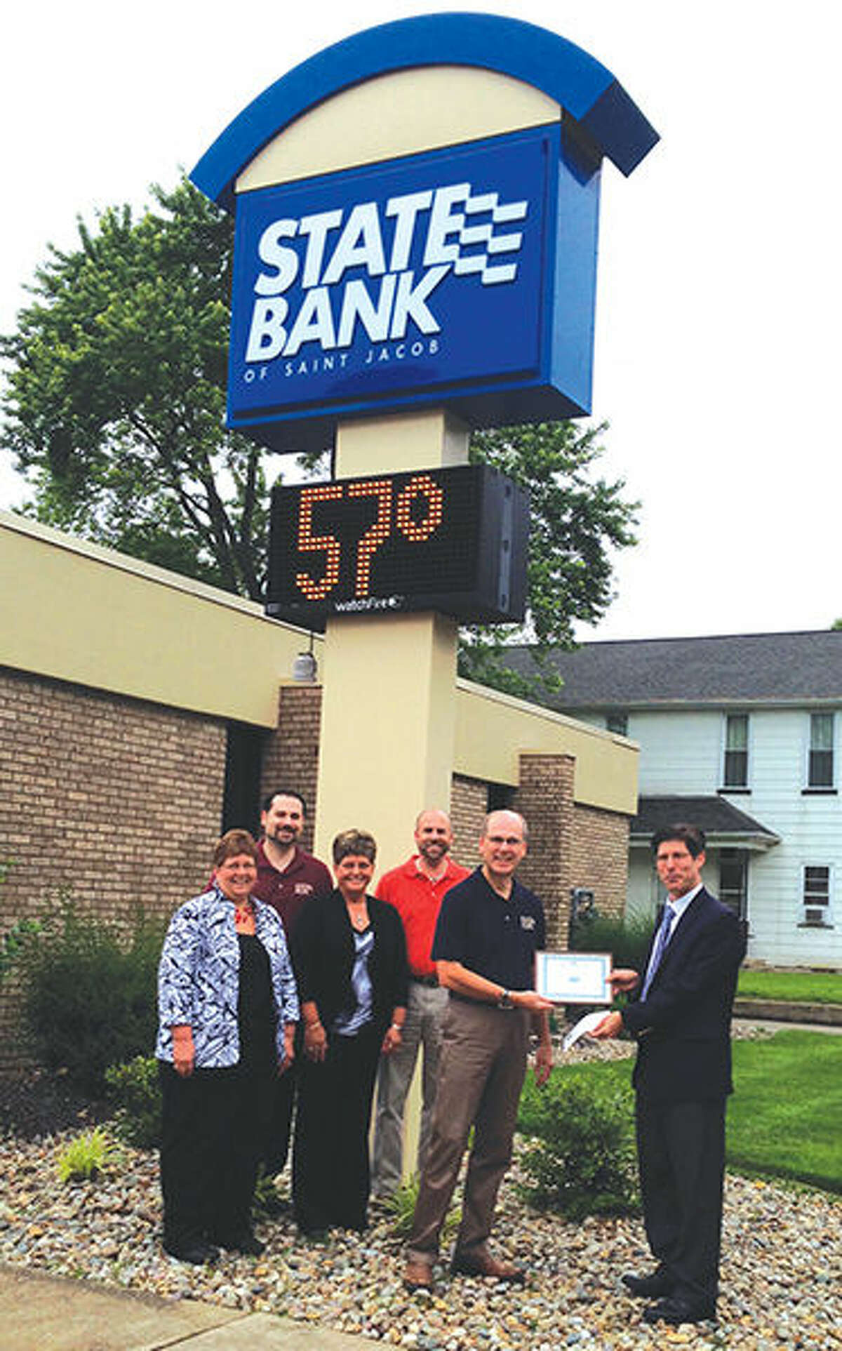 Madison County Treasurer Kurt Prenzler (far right) presents employees of State Bank of St. Jacob with the “Top Performer” certificate in the collection of real estate taxes. Bank employees from left to right: Pam Schuette, Dave Prange, Debbie Seger, Scott Prange and Steve Prange.