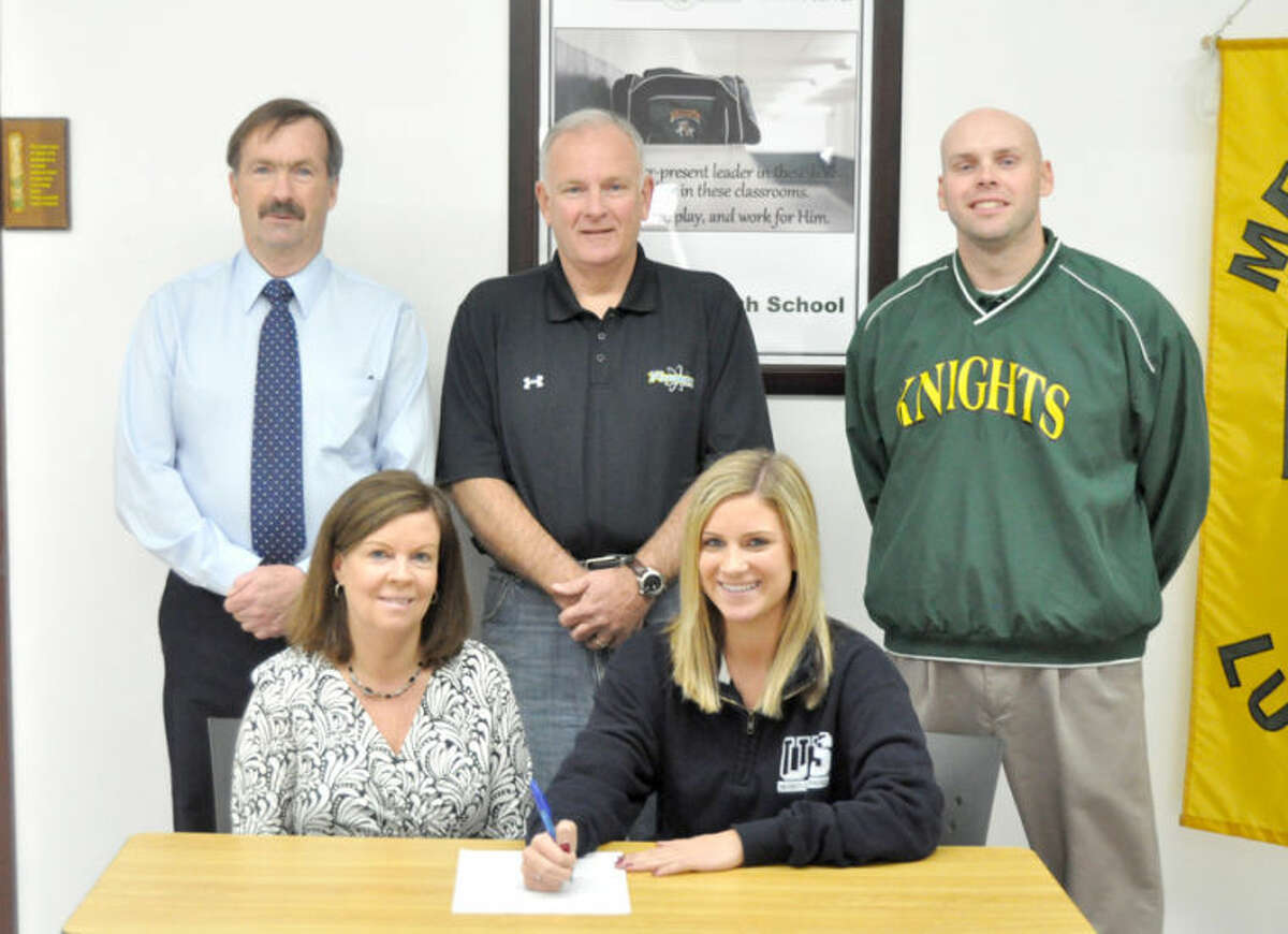 Metro-East Lutheran’s Rachel Goff recently signed a letter of intent to play softball at the University of Springfield. Seated from left to right are: Laura Goff, mother and Rachel Goff. Standing from lef to right are: Dave Redden, MELHS athletic director, Henry Goff, father and Rob Stock, MELHS head softball coach.  