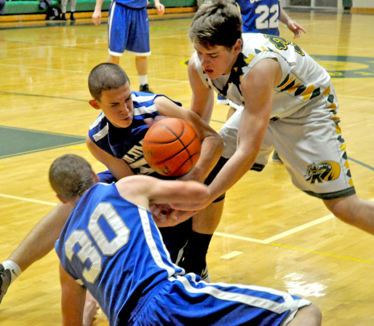 Metro-East Lutheran's Jason Johnson fights with two Columbia players for the ball.