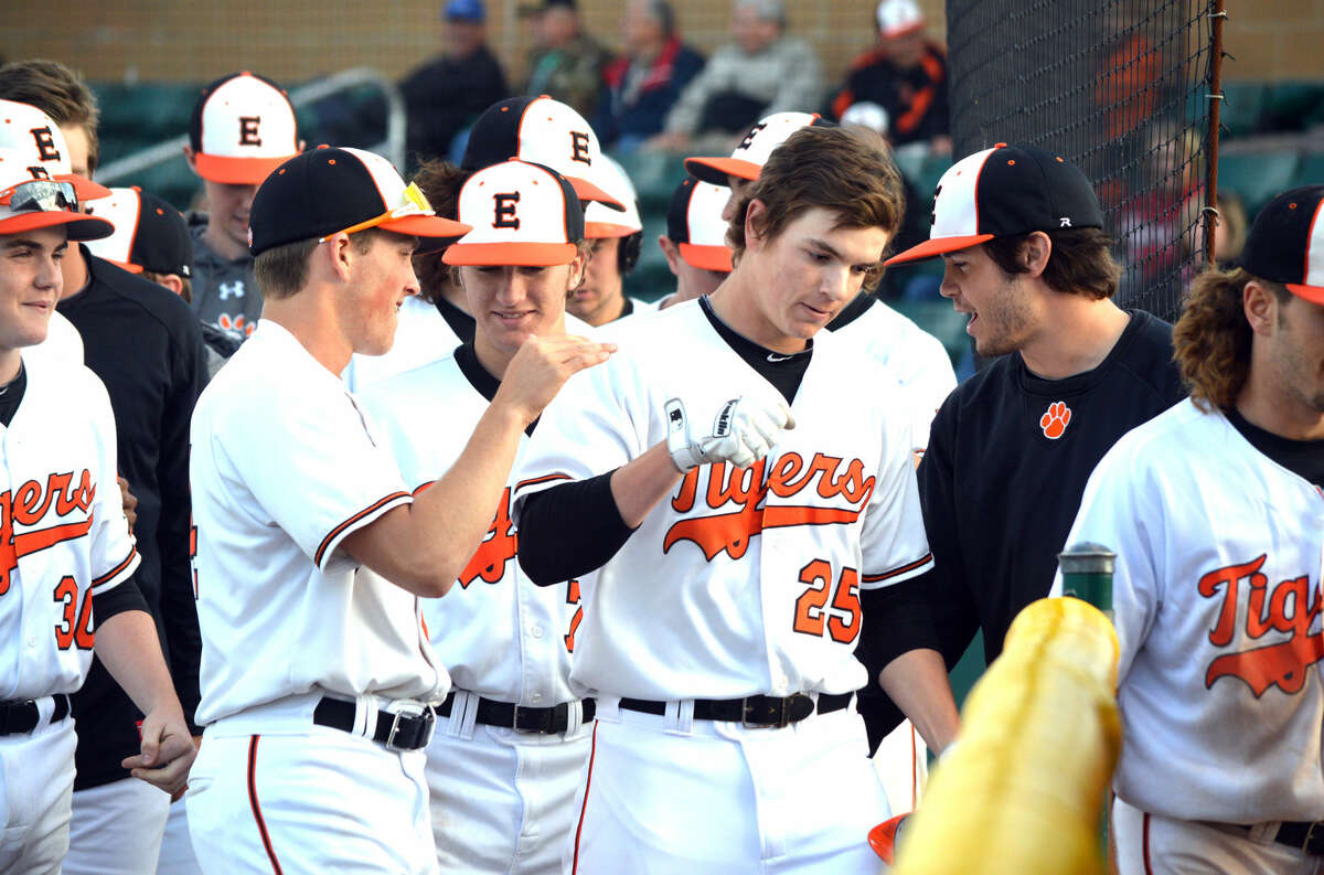 Edwardsville senior Tyler Stamer (25) is congratulated by teammates after his solo home run in the sixth inning. 