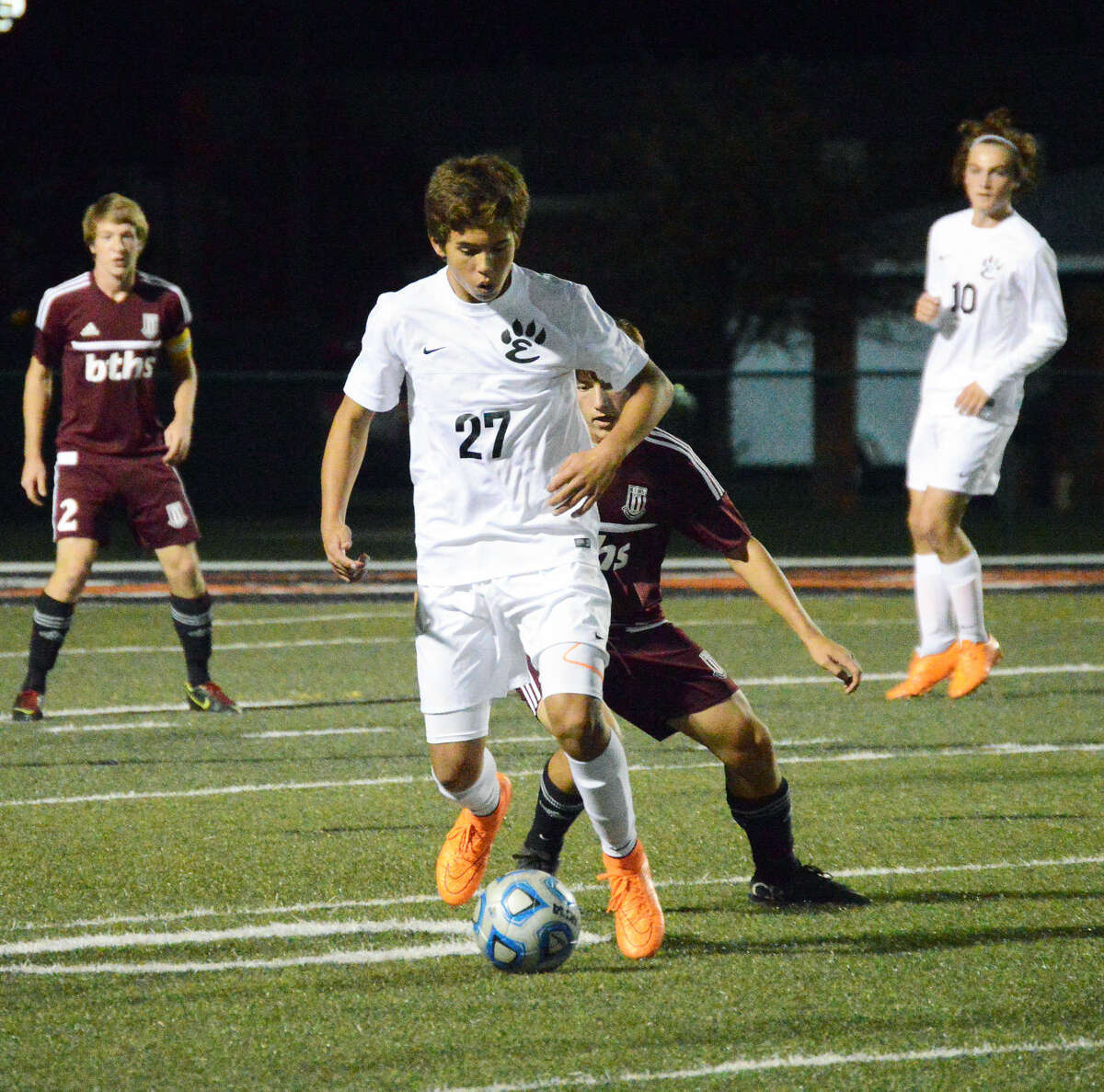 Edwardsville defender Zach Timmerman turns away from a Belleville West defender and looks for an open teammate during the first half. 