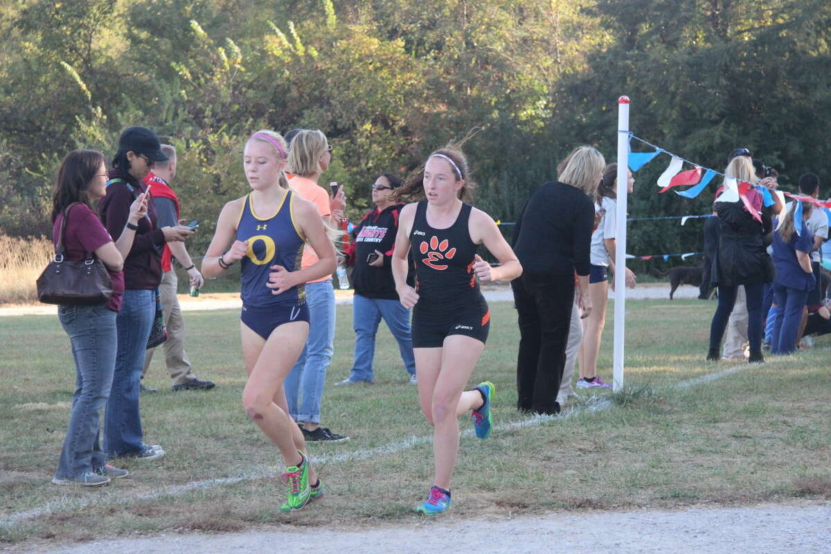 Junior Caitlyn Scheibal keeps up with an O'Fallon runner after the first mile of the junior-senior race.