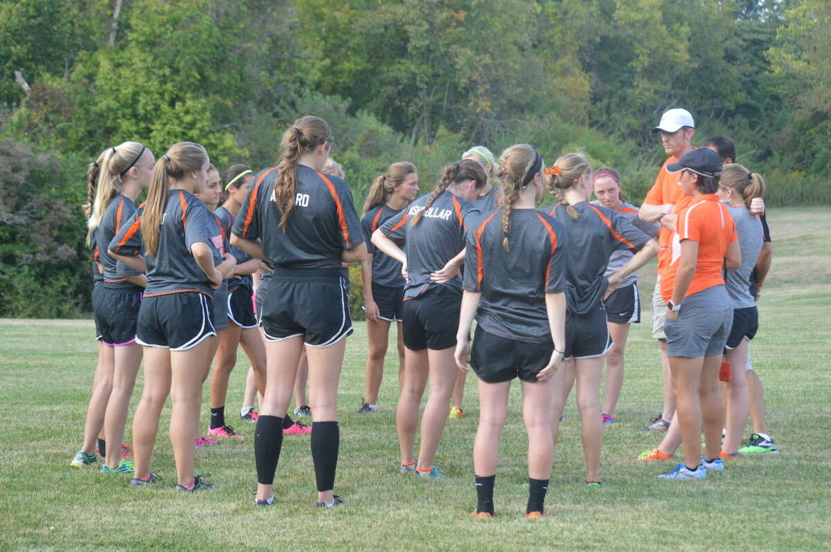 The Edwardsville coaches talk to the girls' team before the start of the Jerseyville Invitational.