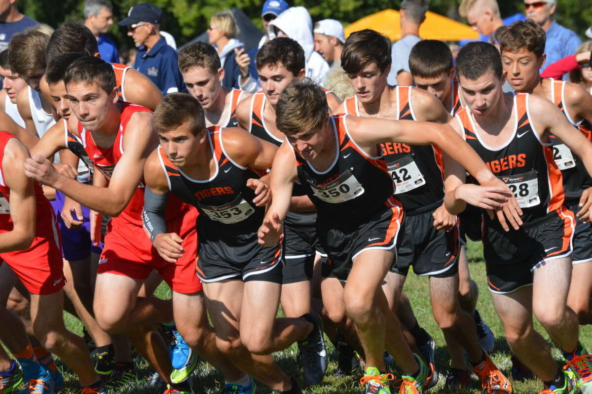 The Edwardsville boys’ cross country team takes off at the start of the Edwardsville Invitational.