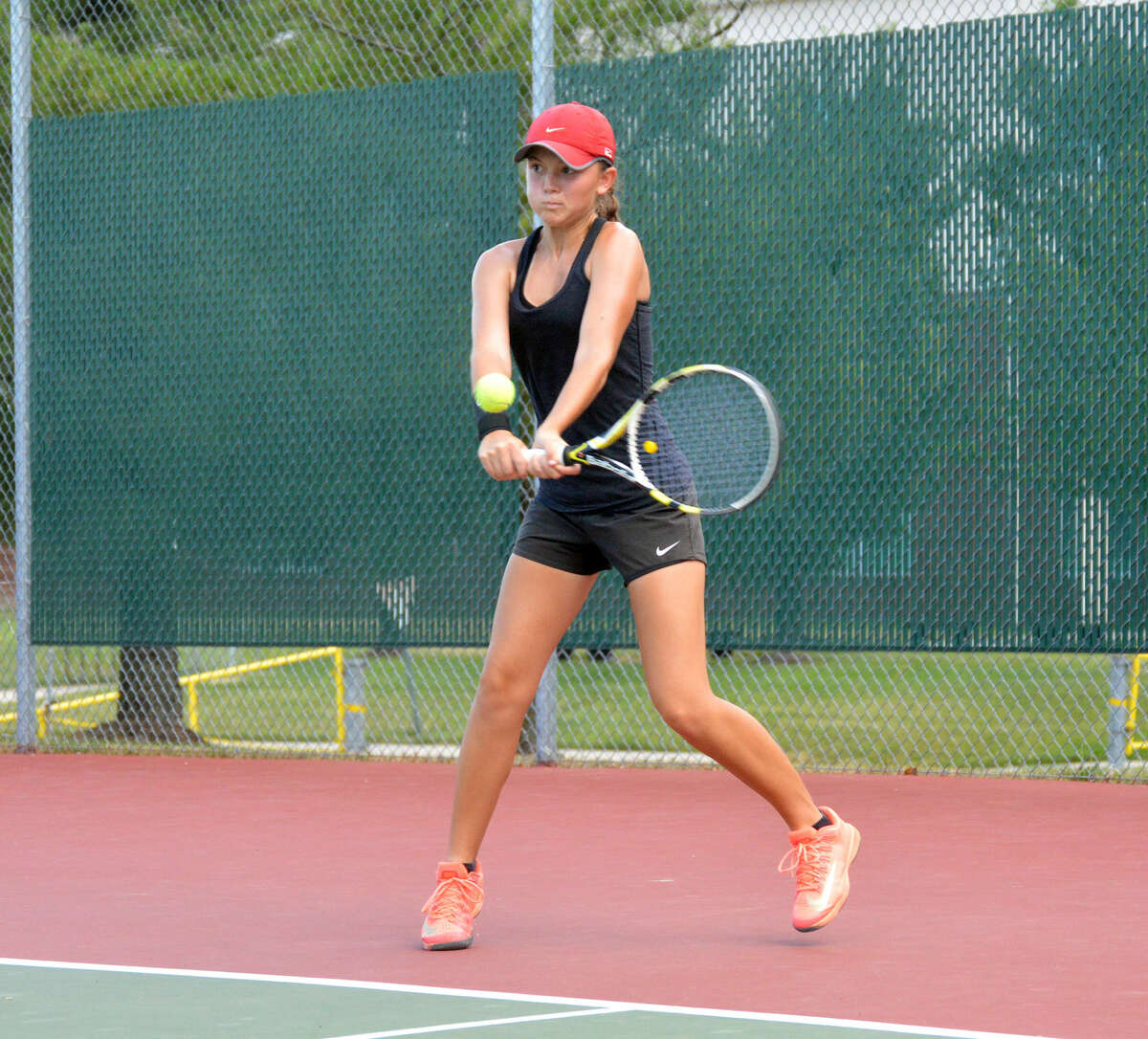 EHS junior Grace Desse returns a serve with a backhand shot at the Tiger Classic on Saturday.