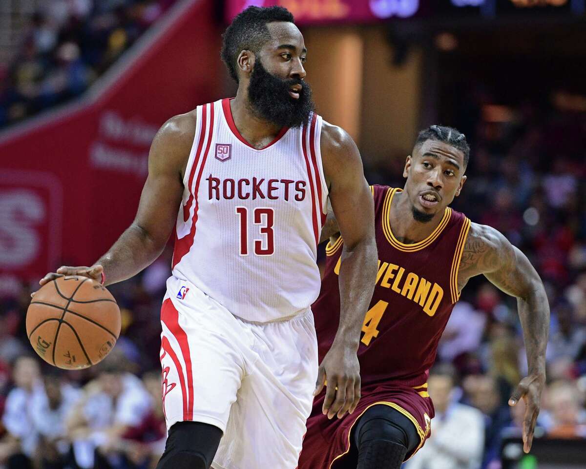Houston Rockets guard James Harden (13) dribbles as Cleveland Cavaliers guard Iman Shumpert (4) closes in during the first half of an NBA basketball game Tuesday, Nov. 1, 2016, in Cleveland. (AP Photo/David Dermer)