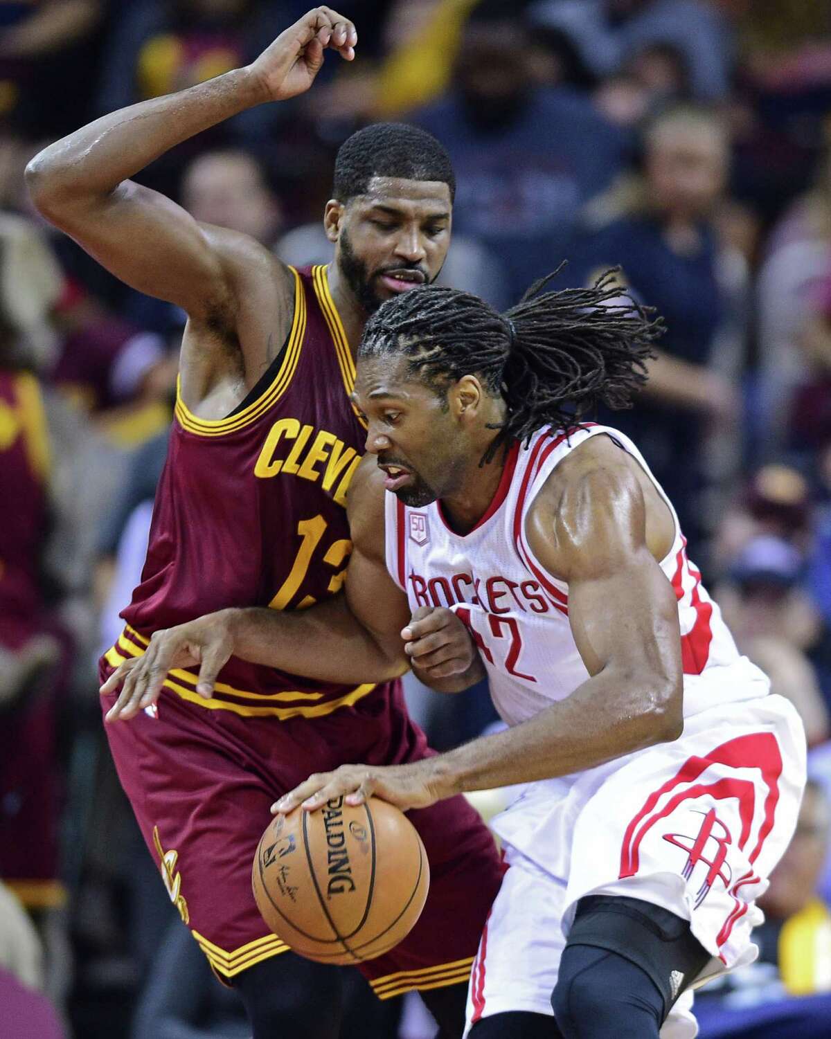 Houston Rockets forward Nene (42) drives on Cleveland Cavaliers forward Tristan Thompson (13) in the first half of an NBA basketball game Tuesday, Nov. 1, 2016, in Cleveland. (AP Photo/David Dermer)