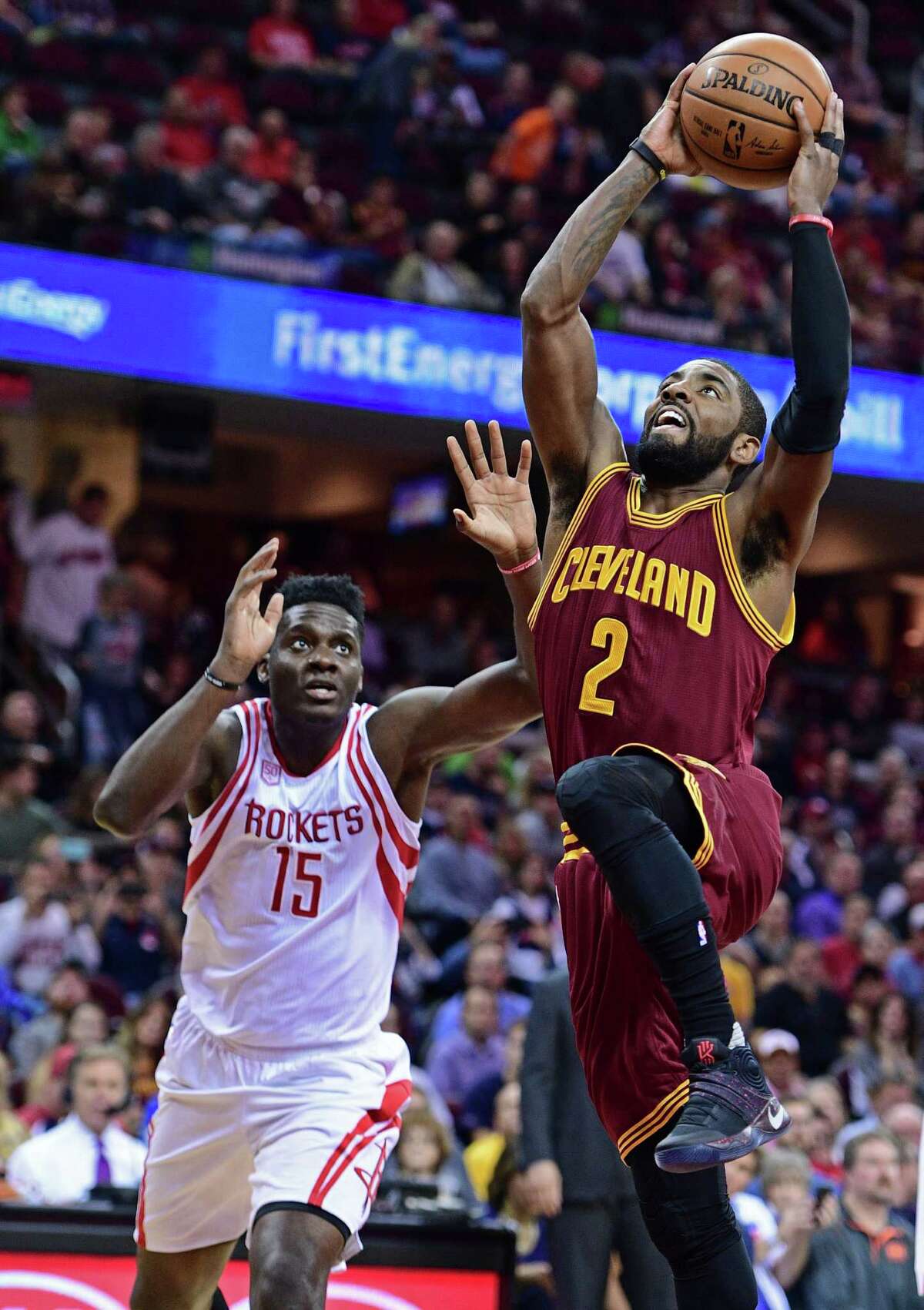 Cleveland Cavaliers guard Kyrie Irving (2) goes in for the dunk while Houston Rockets Clint Capela (15) watches in the first half of an NBA basketball game Tuesday, Nov. 1, 2016, in Cleveland. (AP Photo/David Dermer)