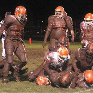 American football player being tackled by opponent player during a match -  a Royalty Free Stock Photo from Photocase