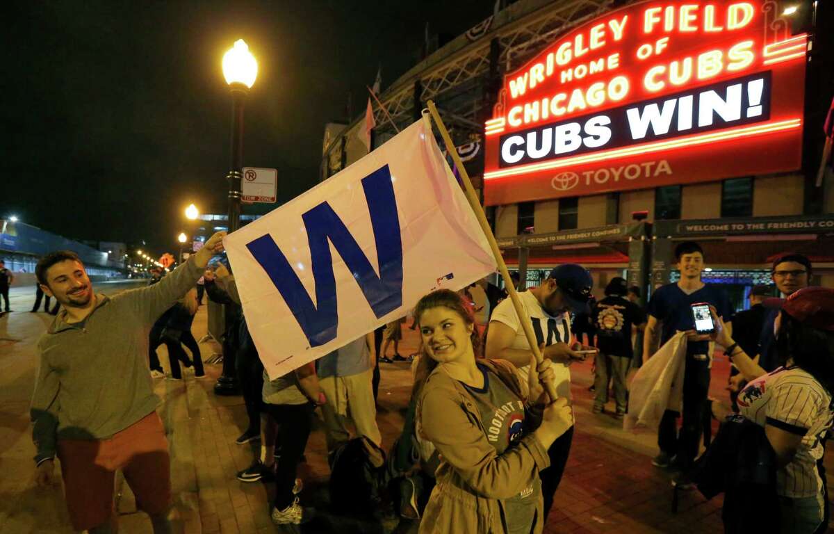Chicago Cubs fans celebrate outside Wrigley Field in Chicago after the Cubs' 9-3 win over the Cleveland Indians in Game 6 of the baseball World Series in Cleveland, Tuesday, Nov. 1, 2016. The Cubs are scheduled to face the Indians in the decisive Game 7 Wednesday.