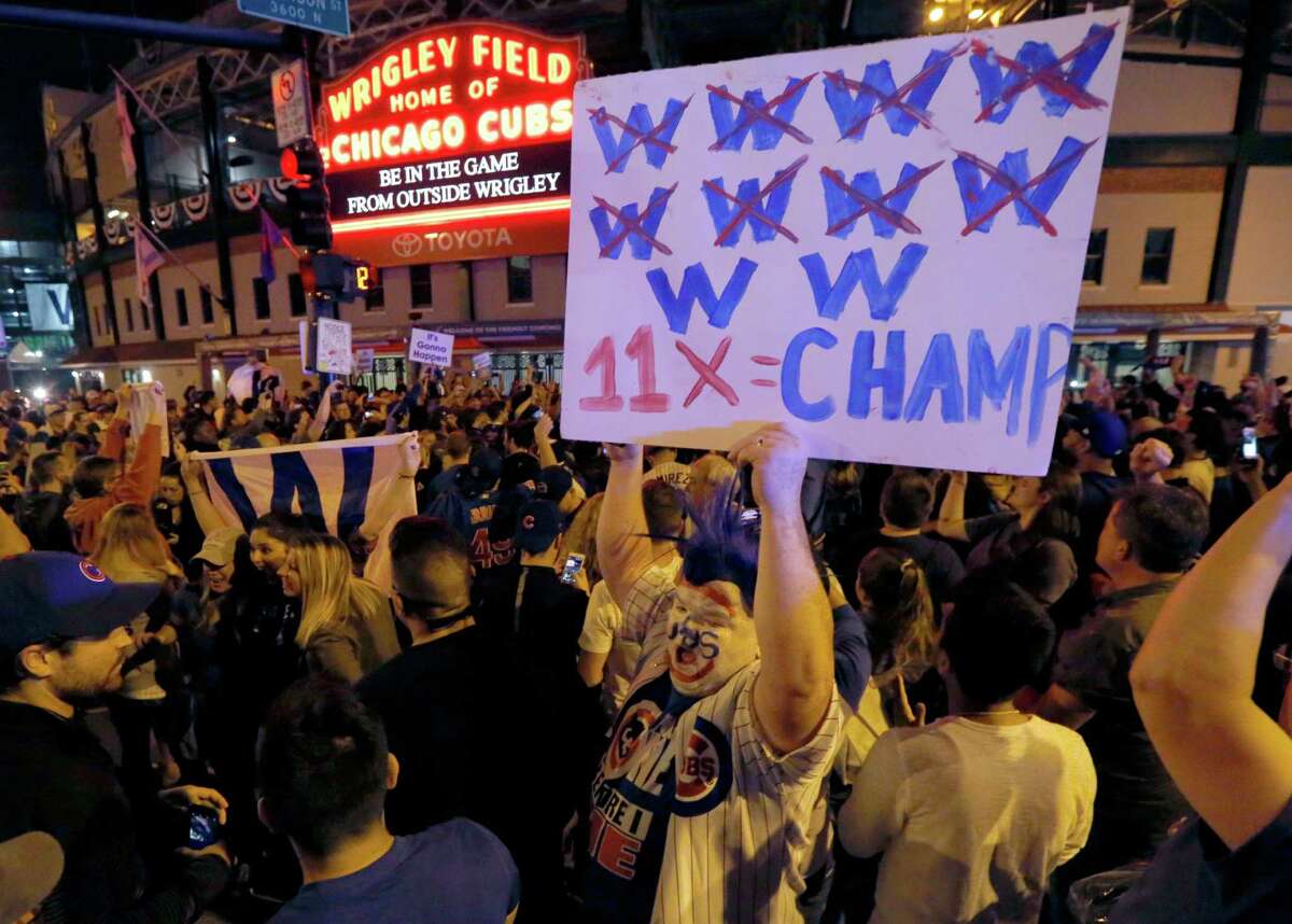 Chicago Cubs fans celebrate outside Wrigley Field in Chicago after the Cubs' 9-3 win over the Cleveland Indians in Game 6 of the baseball World Series in Cleveland, Tuesday, Nov. 1, 2016. The Cubs are scheduled to face the Indians in the decisive Game 7 Wednesday.