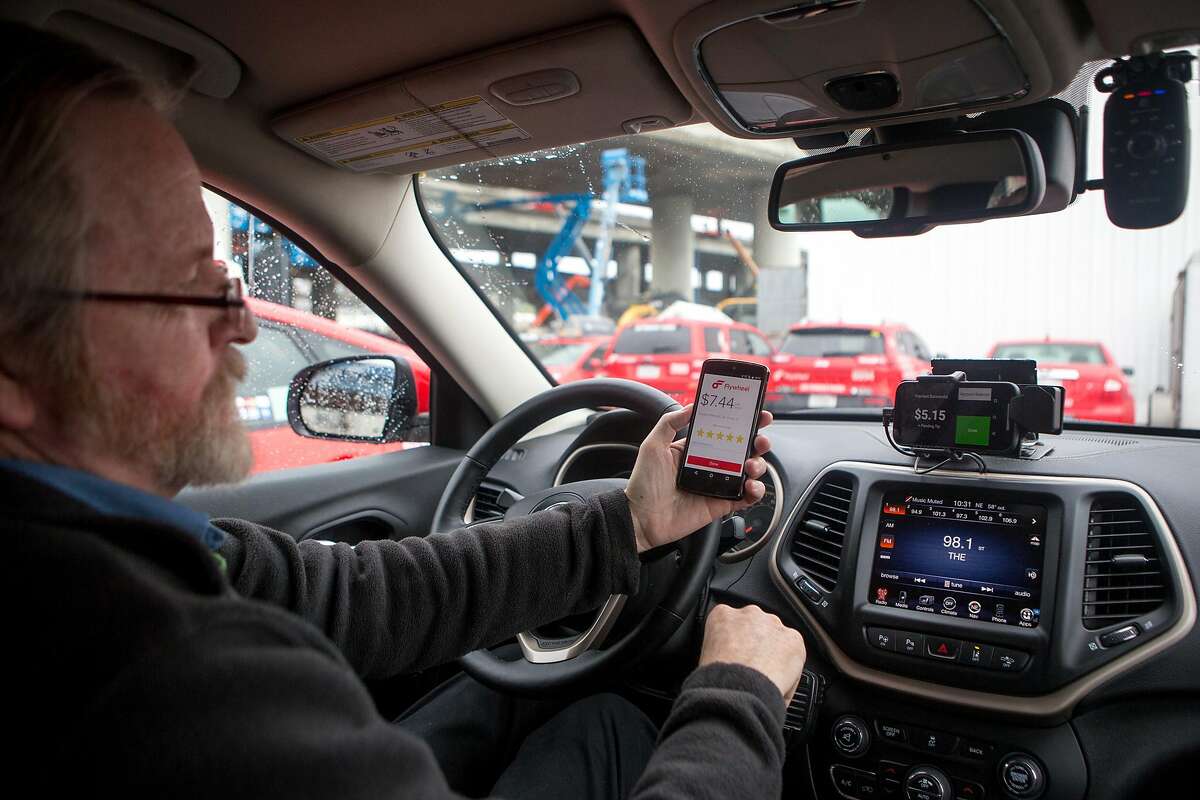 Aaron Small of Flywheel, the company that makes an e-hailing app for taxis, demos the new TaxiOS on Monday, Dec. 21, 2015 in San Francisco, Calif.