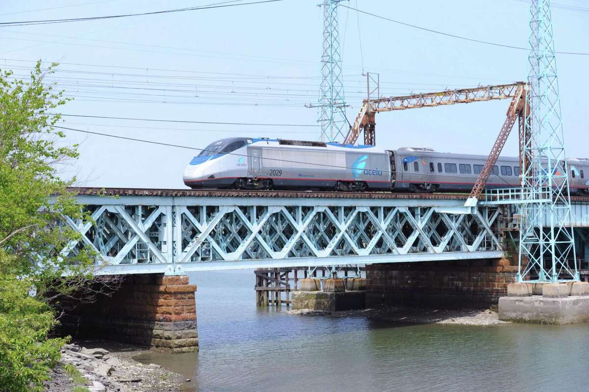 A train travels on the Cos Cob railroad bridge over the Mianus River in Greenwich. Both Tuesday and Wednesday, the bridge has stuck after it has been opened, causing commuter delays.
