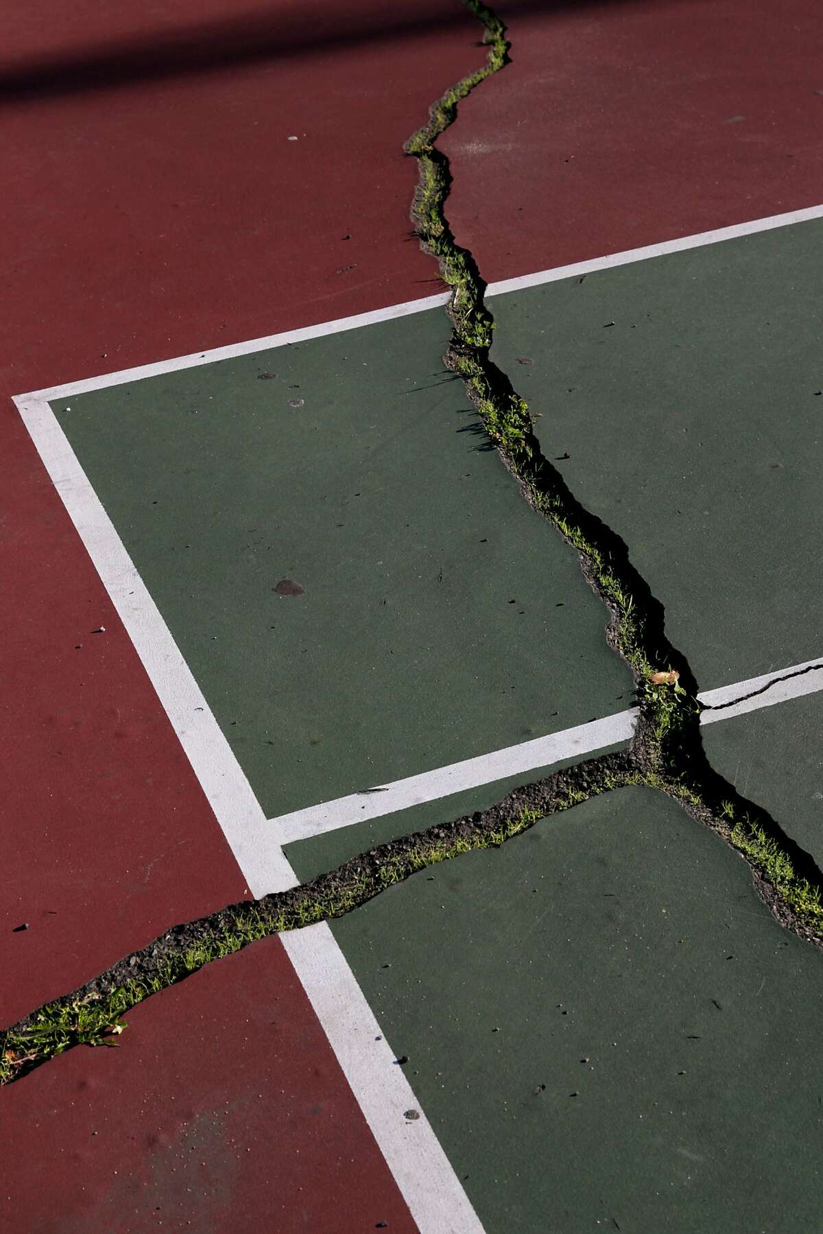 A cracked tennis court at Excelsior Playground on Wednesday, Nov. 2, 2016 in San Francisco, Calif.