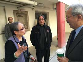 Chang Jok Lee, 89,  talks to Mayor Ed Lee and has lived in Ping Yuen since 1952, when they opened. Photo Credit: Deirdre Hussey