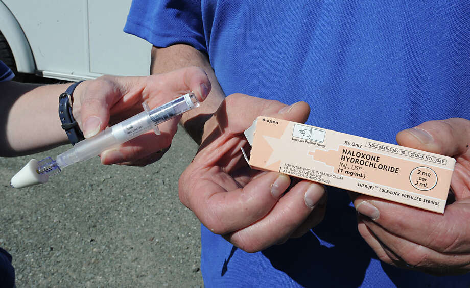 EMTs Carolyn Fleming and Paul Glasser hold the drug Naloxone Hydrochloride at the Hoags Corners ambulance garage Friday, May 18, 2012 in East Nassau, N.Y. State agencies and municipalities will continue to get a discounted price for a heroin antidote through a deal cut by state Attorney General Eric Schneiderman?s office. (Lori Van Buren / Times Union archive) Photo: Lori Van Buren / 00017751A