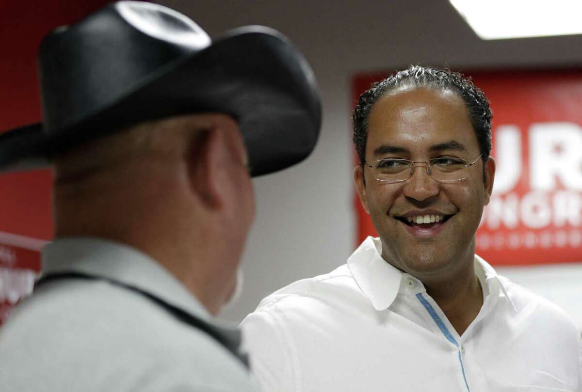 FILE - In this Aug. 27, 2016, file photo, first-term Republican Rep. Will Hurd, right, of Texas, talks with a supporter at a campaign office in San Antonio. Hurd faces former Democratic Rep. Pete Gallego in Texas' 23rd District, which spans 58,000-plus square miles, making it larger than 29 states. (AP Photo/Eric Gay, File)