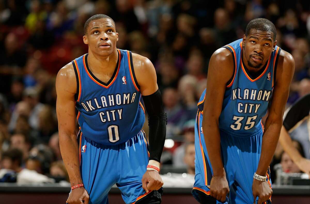 Russell Westbrook #0 and Kevin Durant #35 of the Oklahoma City Thunder stand next to each other during their game against the Sacramento Kings at Sleep Train Arena on January 25, 2013 in Sacramento, California. NOTE TO USER: User expressly acknowledges and agrees that, by downloading and or using this photograph, User is consenting to the terms and conditions of the Getty Images License Agreement. (Photo by Ezra Shaw/Getty Images)