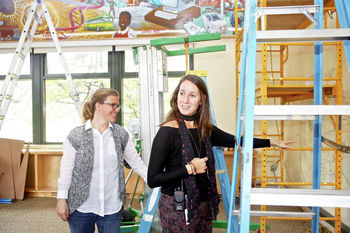 Sarah Mead, director of martketing communications, and Julie Marie Frye, librarian, show student requests for what they would like to make inside of the new maker space being built at the Whitby School library October 28th, 2016.
