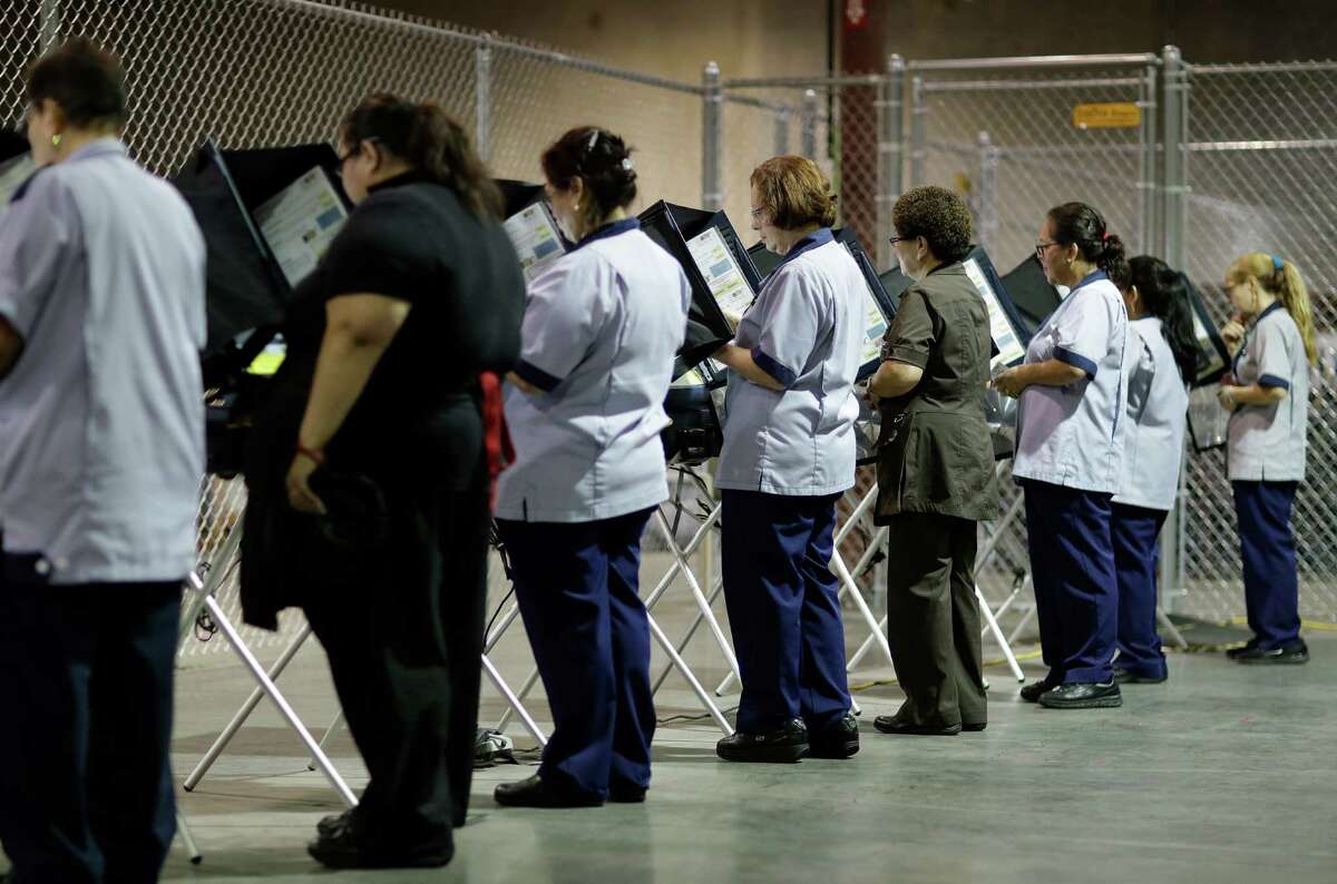 In this Oct. 26, 2016, photo, casino workers vote at an early voting site in Las Vegas. With Election Day approaching, many small businesses want to make it easy for staffers to vote. So theyÂre giving them flex time, balloting breaks or are opening several hours late. (AP Photo/John Locher)