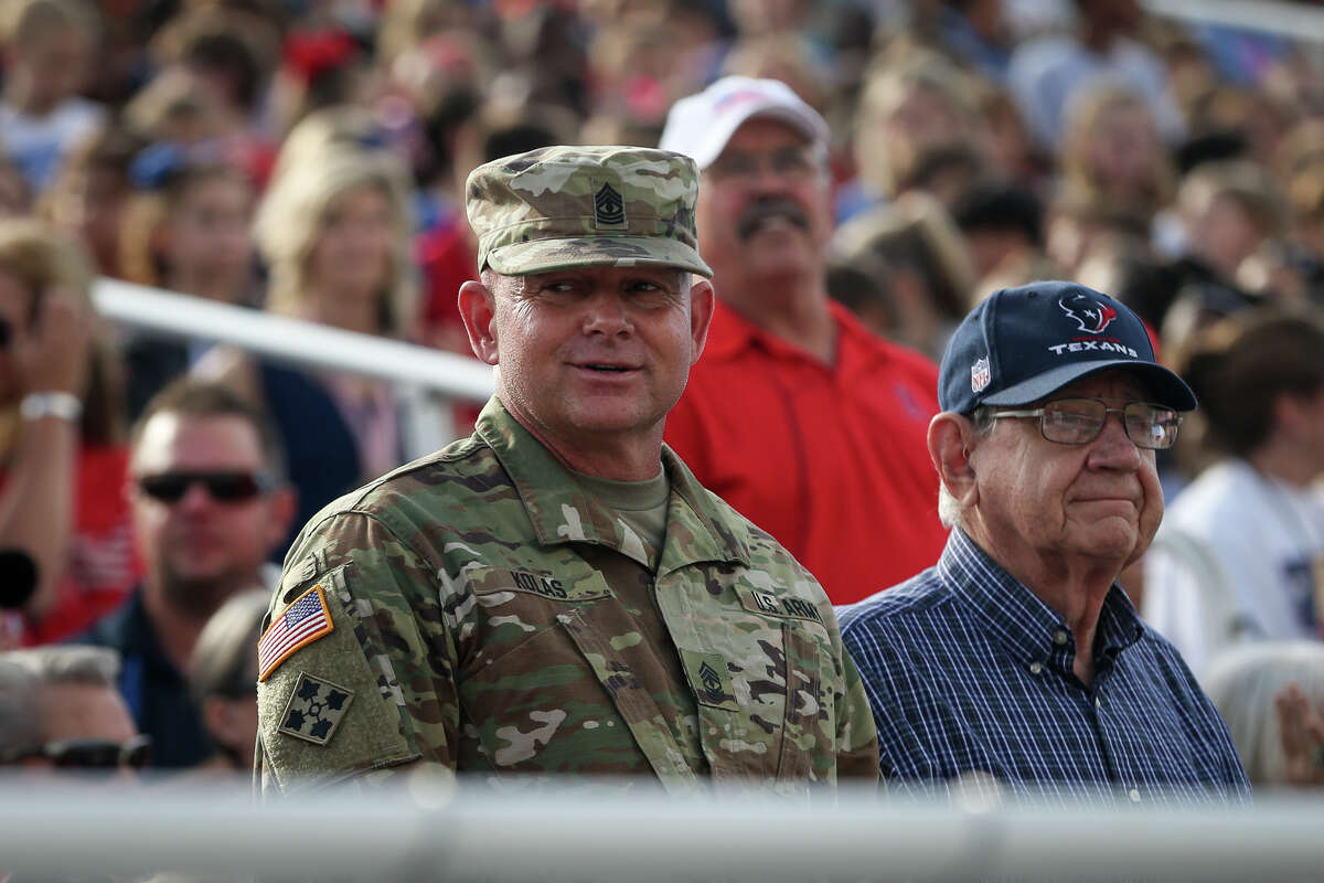 Veterans and service members stand as their military branch's songs are played during the Veterans Day Celebration on Tuesday, Nov. 1, 2016, at Bears Stadium in Montgomery.