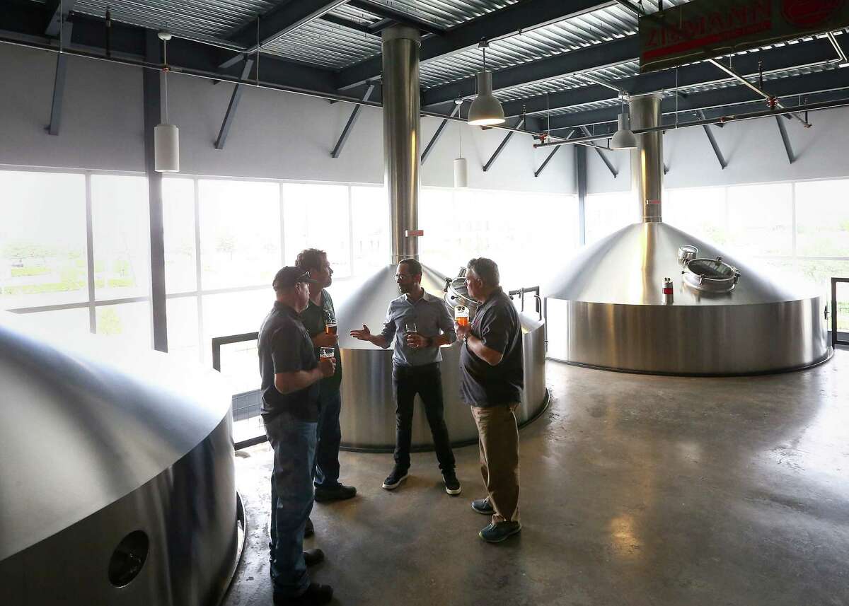 Chuck Robertson, from left, co-founder of Karbach Brewing Co., Eric Warner, brewmaster at Karbach Brewing Co., Felipe Szpigel, president of Anheuser-BuschInBez's High End business unit, and Ken Goodman, co-founder of Karbach Brewing Co., talk as they stand in the brewhouse at Karbach brewery, Thursday, Nov. 3, 2016, in Houston. Anheuser-Busch announced that they will acquire Karbach Brewing Co. ( Jon Shapley / Houston Chronicle )