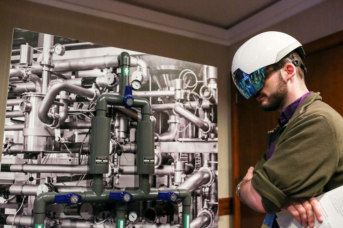 Matthew Noyas tries out the Daqri Smart Helmet at the Virtual Reality Developers Conference on Thursday, Oct 3, 2016 in San Francisco, Calif.