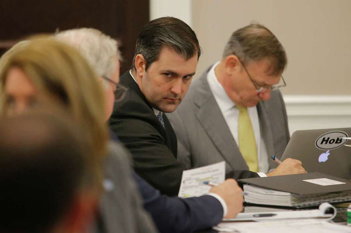 Former North Charleston Police Officer Michael Slager, second from right, sits at the defense table and listens to his lawyer in the courtroom, Thursday, Nov. 3, 2016 in Charleston, S.C. Slager faces 30 years to life if convicted of murder in the April 2015 death of Scott, whose shooting, captured on a bystander's dramatic cellphone video, spread on social media and stunned the nation. (Grace Beahm/Post and Courier via AP, Pool, File)