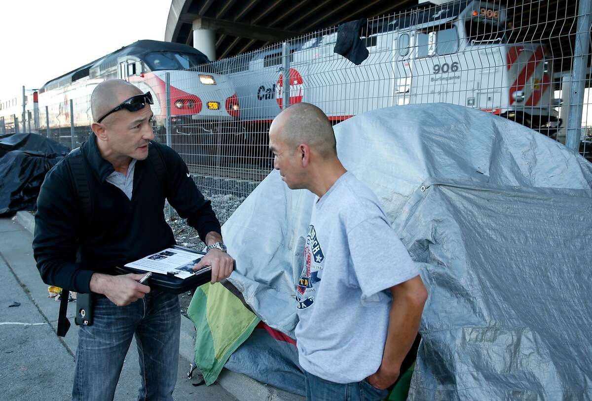 Dennis Johnson, an outreach specialist with Swords to Plowshares, enrolls Army veteran Enrico Cruz (right) into services for homeless veterans in San Francisco, Calif. on Thursday, Nov. 3, 2016. Cruz is one of the residents of a homeless encampment on Seventh Street next to the Caltrain tracks.