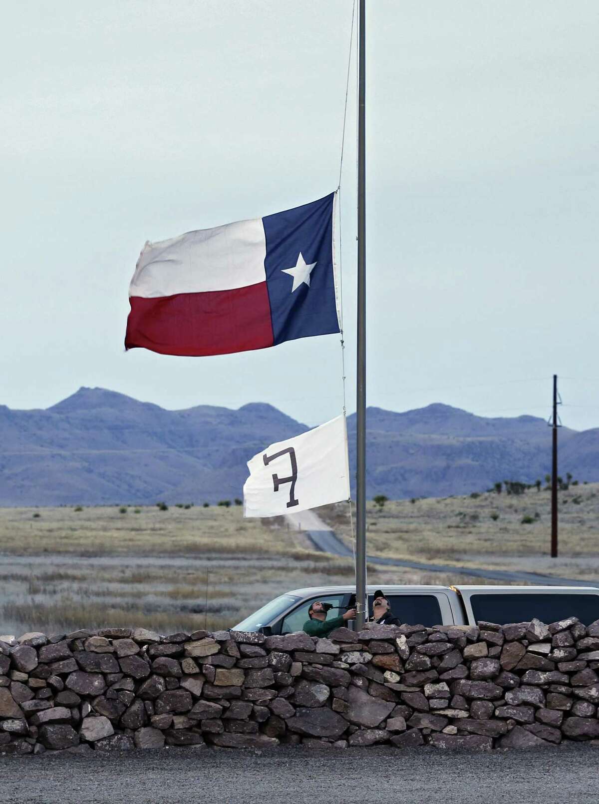 CIBOLO CREEK RANCH, TX - FEBRUARY 13, 2016 - Ranch staff lower the Texas and ranch flag to half staff at Cibolo Creek Ranch south of Marfa, Texas where Supreme Court Justice Antonin Scalia died Saturday. (Photo by Erich Schlegel)