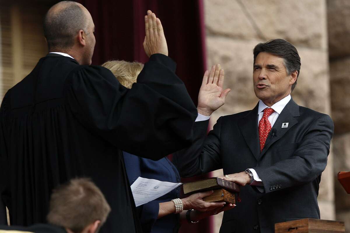 Texas Governor Rick Perry, right, is sworn-in by Supreme Court of Texas Chief Justice Wallace B. Jefferson during the 2011 Texas Inauguration Oath of Office Ceremony on the South Steps of the Texas Capitol in Austin, Tuesday, Jan. 18, 2011. It is Perry's fourth oath ceremony and Lt. Gov. David Dewhurst took the oath for a third term.