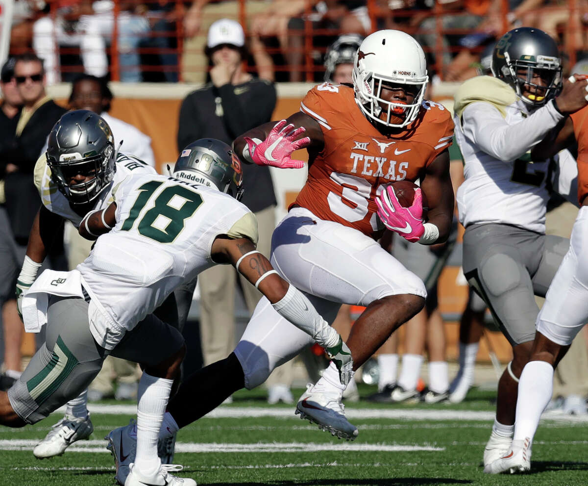 FILE - In this Saturday, Oct. 29, 2016, file photo, Texas running back D'Onta Foreman (33) runs past Baylor safety Chance Waz (18) during an NCAA college football game in Austin, Texas. Foreman leads the Big 12 with 158 yards rushing per game, which is second nationally, and already has the LonghornsÂ?’ first 1,000-yard season since Jamaal Charles in 2007. (AP Photo/Eric Gay, File)