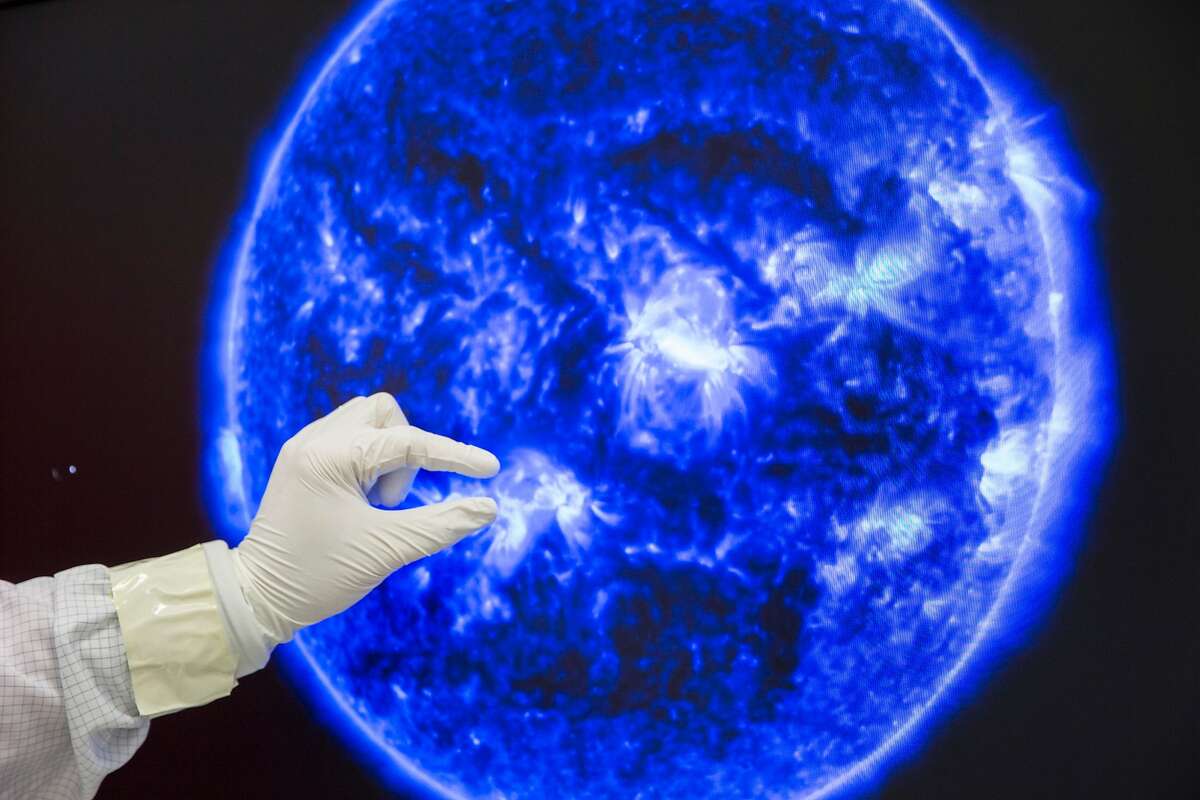 Mark E. Lewis points to the Atmospheric Imaging Assembly (AIA) pictures of the sun, pictured Thursday, Nov. 3, 2016 in Palo Alto, Calif. Lewis is Lockheed Martin's communication lead in technology and innovation. Lockheed Martin, an aerospace company, built an updated version that will replace the current AIA.