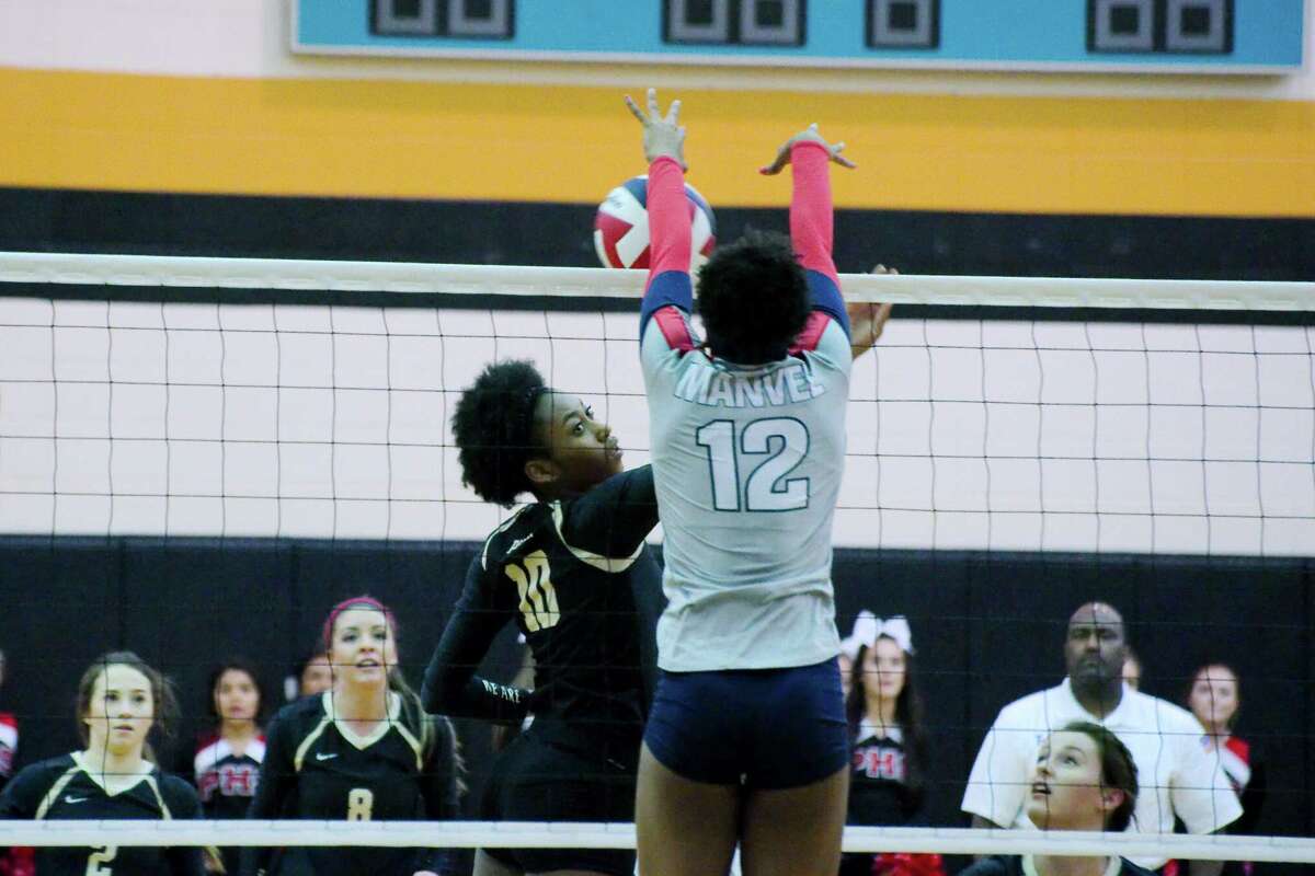 Porter's Shelby WilliamsÊ(10) goes face-to-face with Manvel's Delaine Fulton (12) at the net Thursday, Nov. 3 at Pasadena Memorial High School.