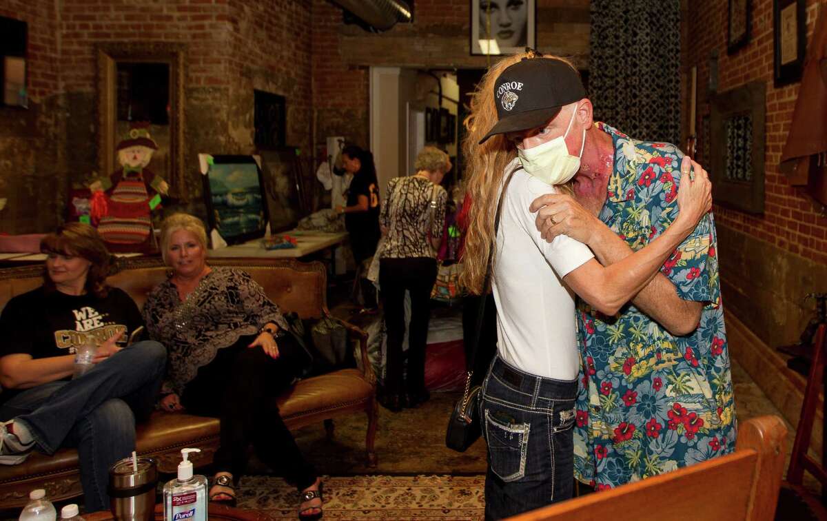 Kam Hutchins gets a hug from Rhonda McLaughlin during his 55th birthday party at MartinÃ©?•s Hall Thursday, Nov. 3, 2016, in Conroe. The event also served as a medical fundraiser for Hutchins, a retired teacher at Hauke and 1980 graduate of Conroe High School, who is battling tonsil cancer.