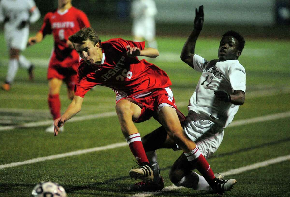 Fairfield Prep's Brian Donahue, left, and Shelton's Khaleed Dawkins collide while chasing the ball during SCC soccer championship action in West Haven, Conn. on Thursday Nov. 3, 2016.