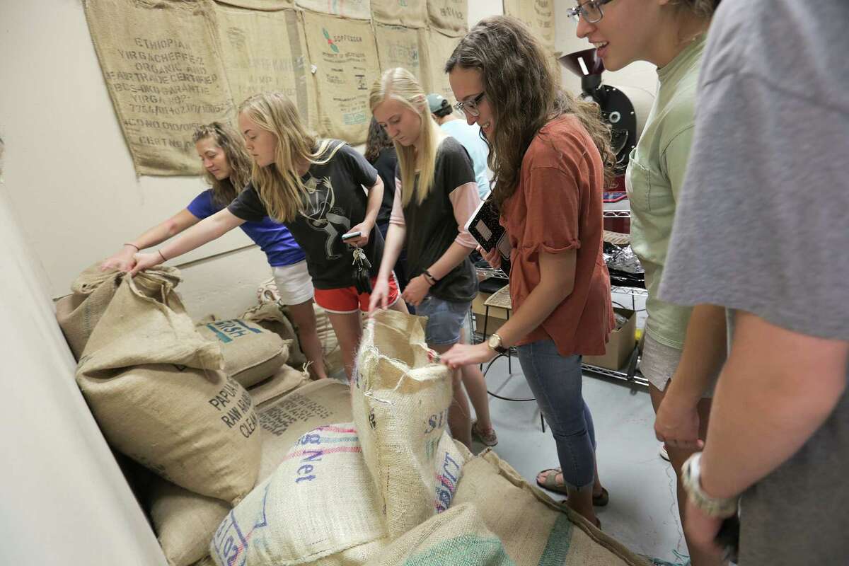 Texas A&M students check out raw coffee beans at What's the Buzz coffee roaster as part of a class trip with professor Leo Lombardini, on Thursday, Oct. 20, 2016, in College Station.