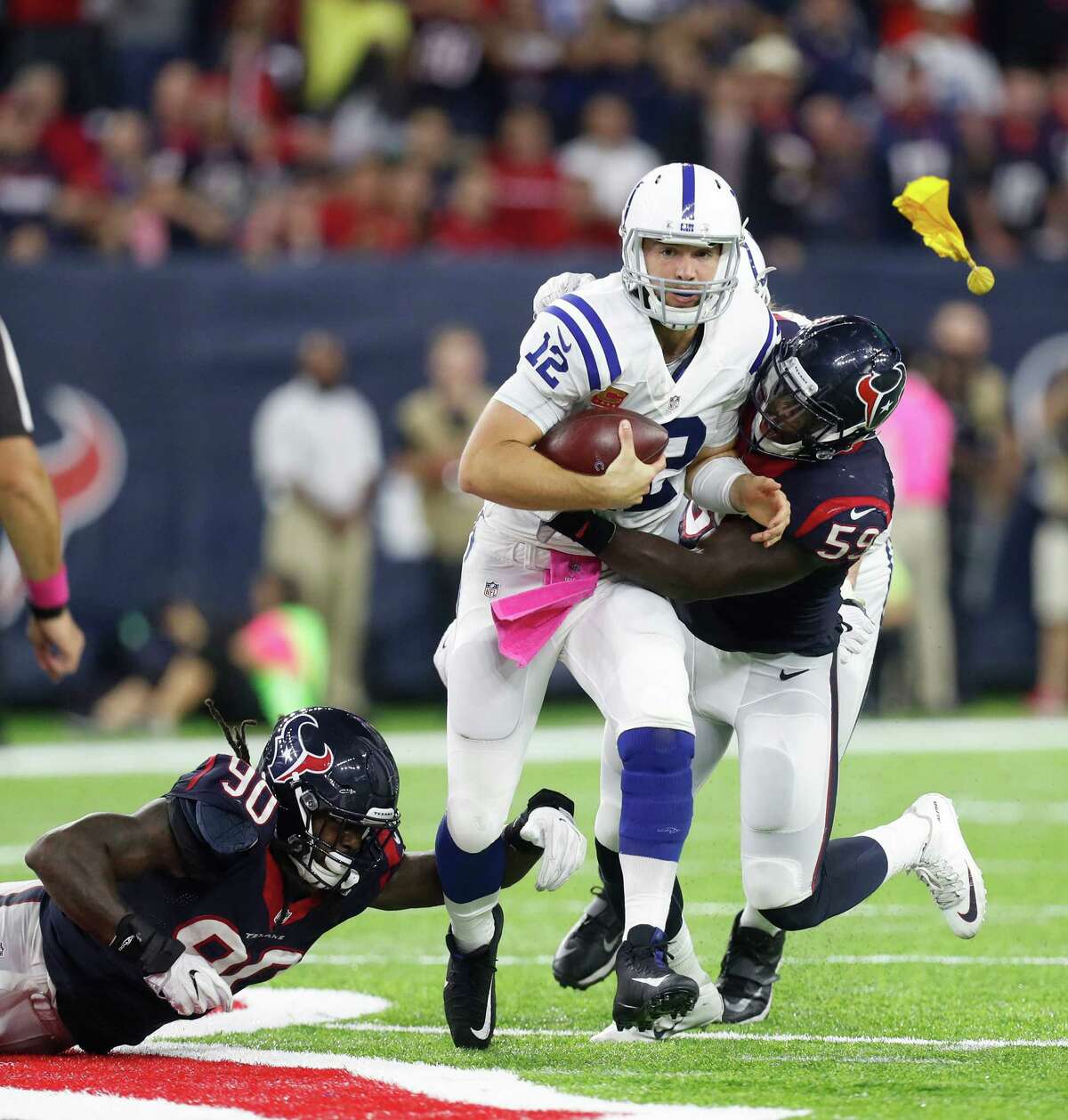 Indianapolis Colts quarterback Andrew Luck (12) is sacked by Houston Texans outside linebacker Whitney Mercilus (59) and defensive end Jadeveon Clowney (90) during the third quarter of an NFL football game at NRG Stadium, Sunday,Oct. 16, 2016 in Houston. ( Karen Warren / Houston Chronicle )