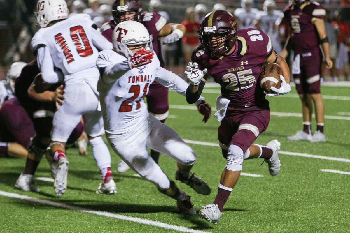 Magnolia West's Bryce Williamson (25) runs the ball as Tomball's Brock Knighten (21) defends during the varsity football game on Friday, Oct. 28, 2016, at Mustangs Stadium in Magnolia, Texas. (Michael Minasi / Chronicle)