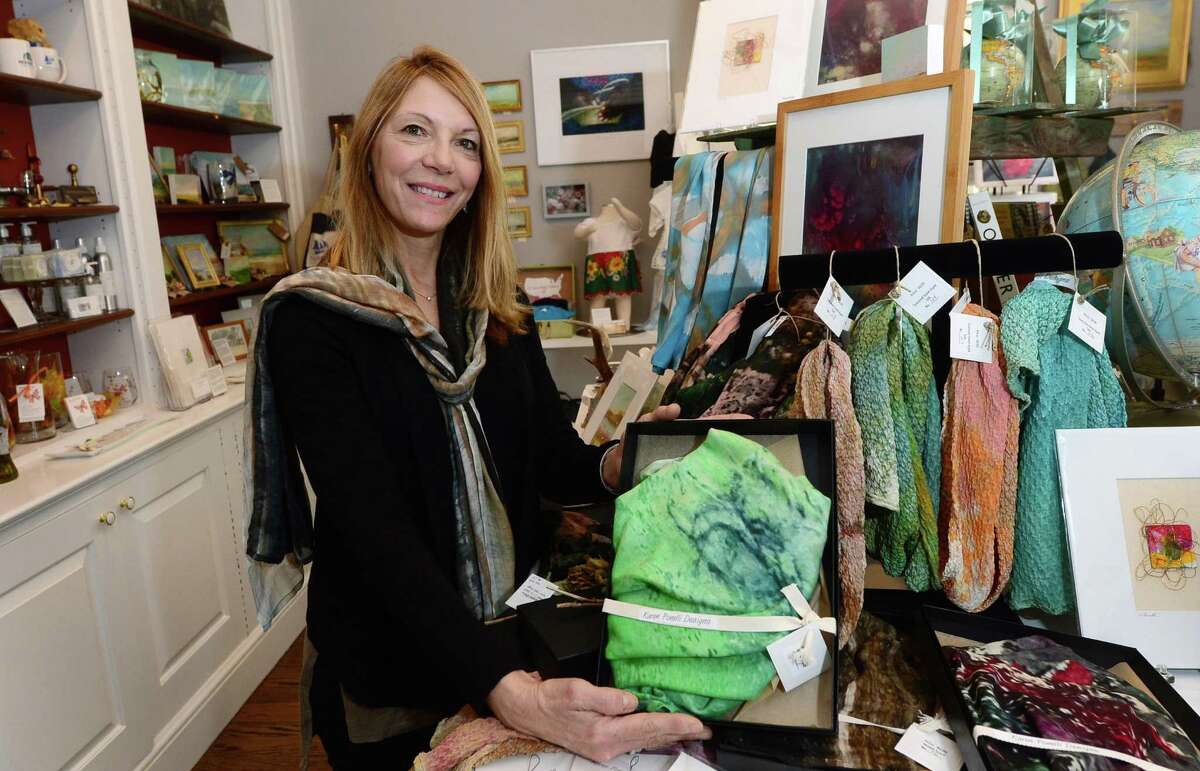 Artist/designer Karen Ponelli with her work that includes scarves, paintings and jewelry, which is for sale at the Norwalk Museum Gift Shop Wednesday, November 2, 2016, in Norwalk, Conn. Ponelli's work will be featured at the Sip and Shop at the Museum November 9th Dress for Success fundraiser hosted by the Norwalk Historical Society which will collect business clothes for underprivileged women in the community hoping to re-enter the workforce.